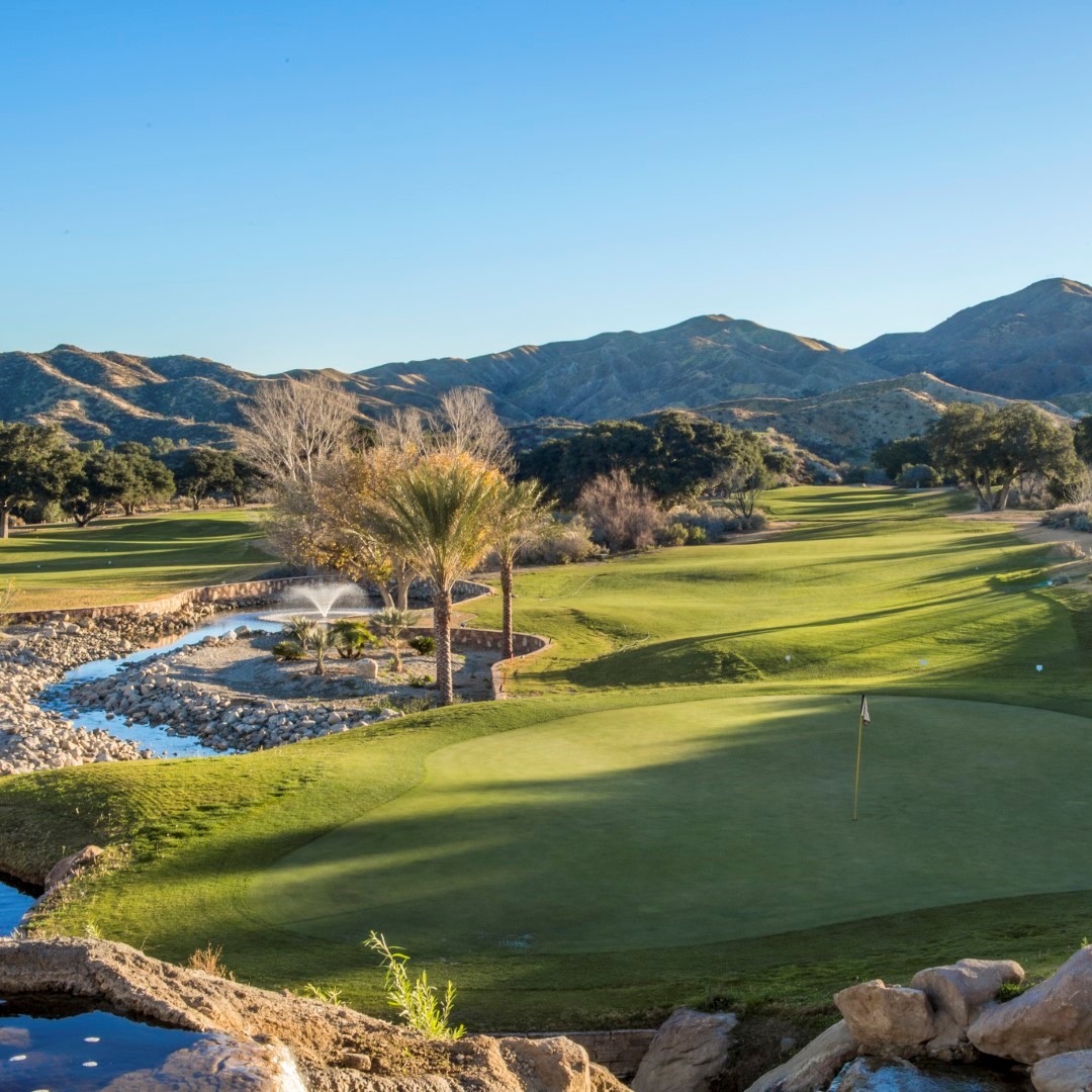 View of the Sand Canyon Country Club golf course showing the scenic Angeles National Forest surrounding it.