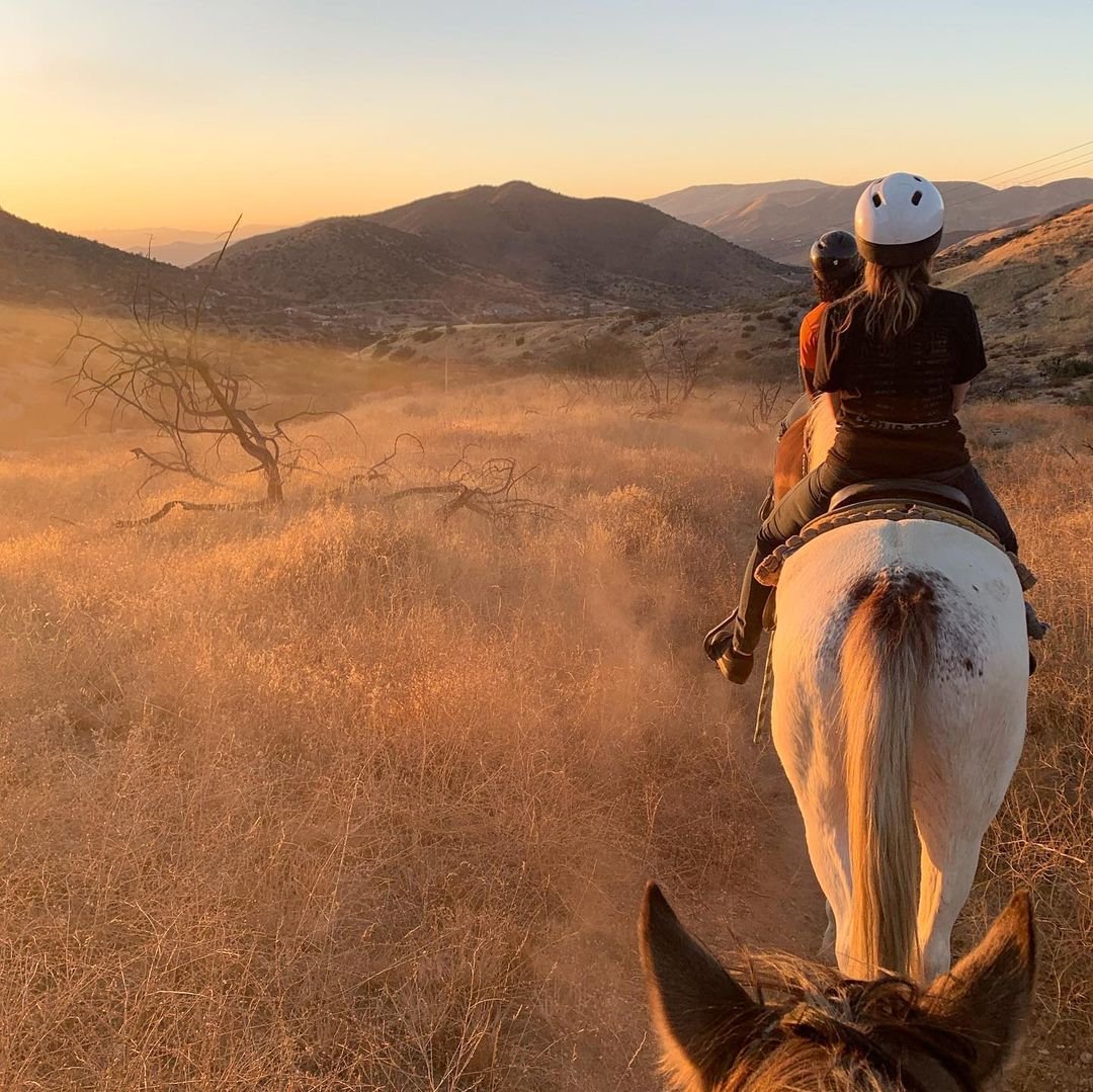 Group of people riding horses on a trail at the Rainbow Ridge Ranch in Santa Clarita.