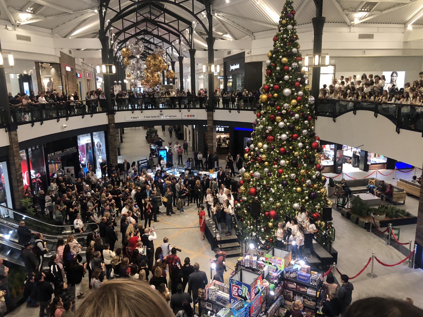 Christmas tree display with large crowd inside of local shopping area in Santa Clarita.