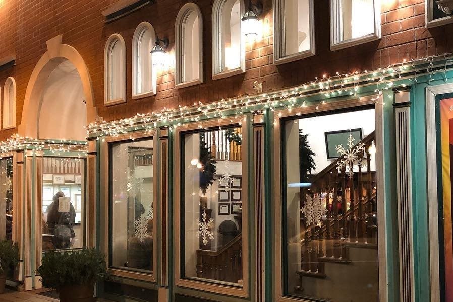 Photo in front of the Canyon Theatre Guild building during Christmas time with lights around the building.