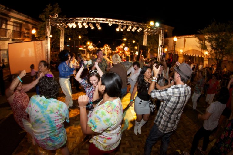 Group of people dancing outside at SENSES Block Party on Main Street in Santa Clarita.